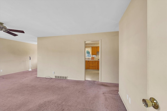 empty room with light carpet and ceiling fan