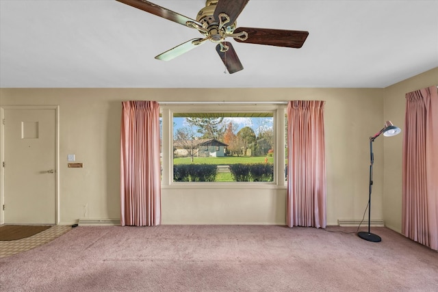 carpeted empty room featuring ceiling fan