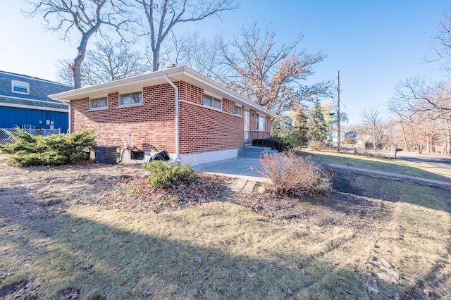 view of property exterior featuring cooling unit, a patio area, and a yard