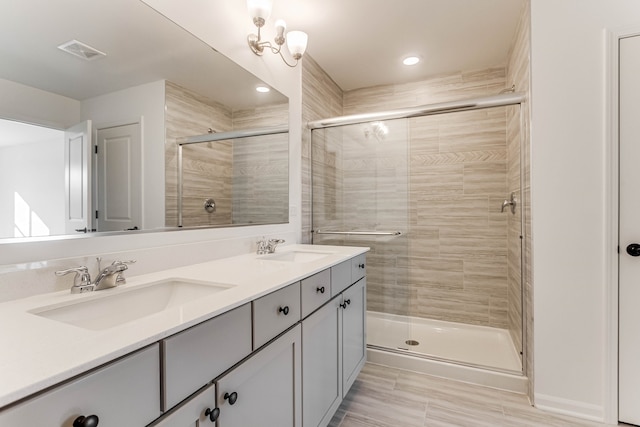 bathroom featuring hardwood / wood-style floors, vanity, and a shower with shower door