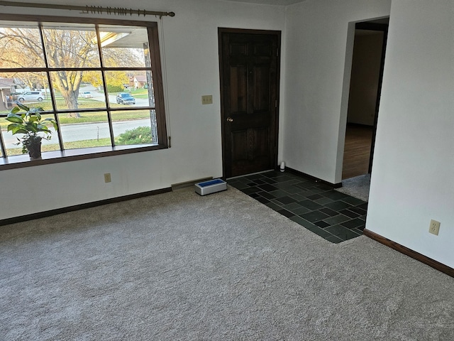 spare room with dark carpet