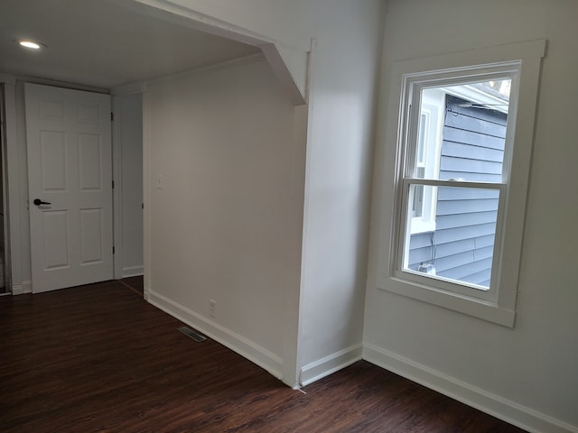 unfurnished room featuring dark wood-type flooring