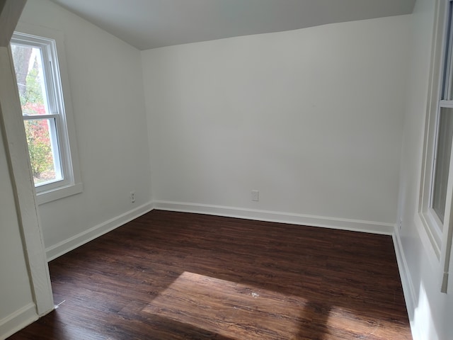 unfurnished room featuring dark wood-type flooring