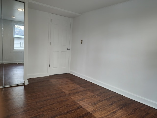 spare room featuring dark wood-type flooring