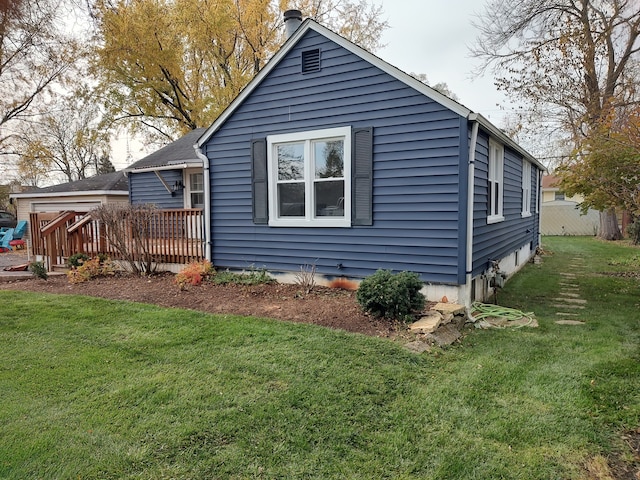 back of house featuring a yard and a deck