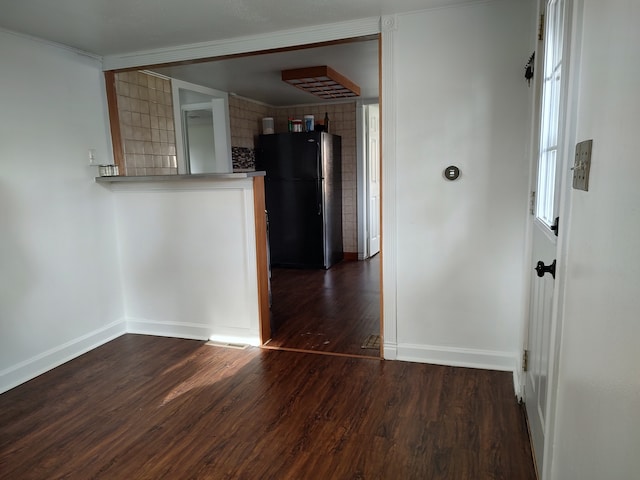 interior space with dark hardwood / wood-style floors and crown molding