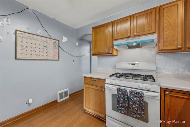 kitchen featuring light hardwood / wood-style flooring and white range with gas cooktop