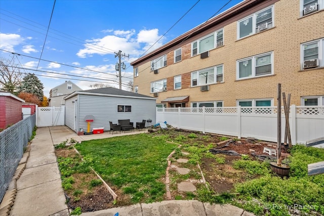 rear view of house with a yard, cooling unit, and a patio area