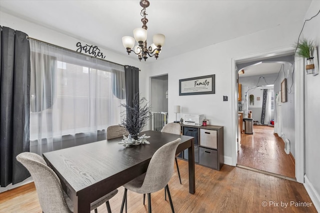 dining room featuring hardwood / wood-style floors and a notable chandelier