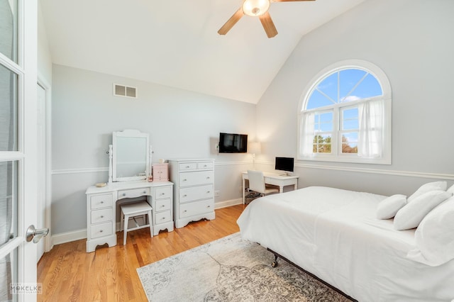 bedroom with ceiling fan, vaulted ceiling, and light wood-type flooring