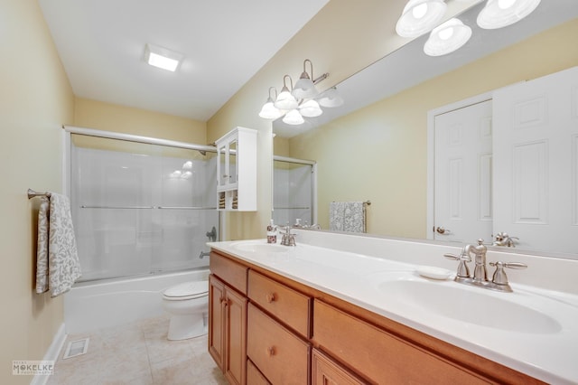 full bathroom with bath / shower combo with glass door, vanity, a notable chandelier, tile patterned flooring, and toilet