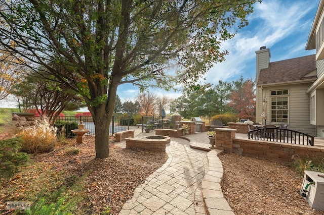 view of yard with an outdoor kitchen and a patio