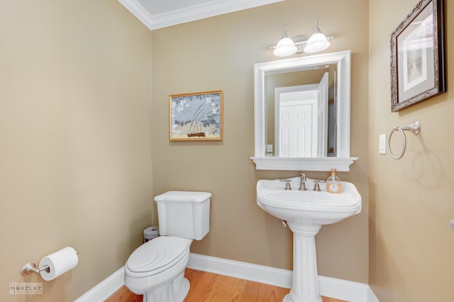 bathroom featuring hardwood / wood-style floors, toilet, and crown molding