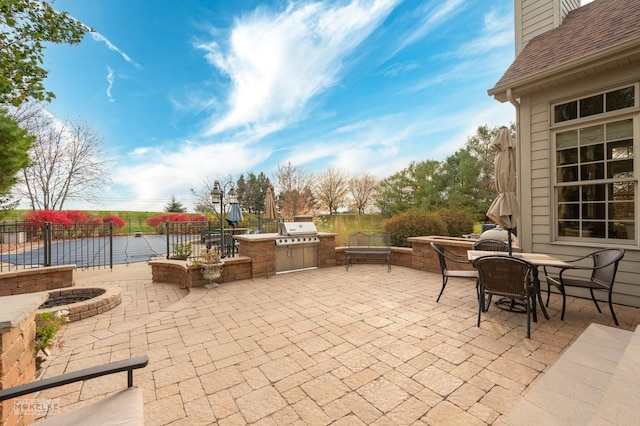 view of patio featuring area for grilling, a water view, and grilling area