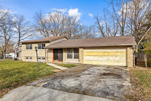 tri-level home with a front lawn and a garage