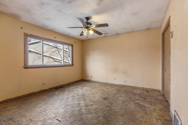 unfurnished room with parquet flooring and ceiling fan