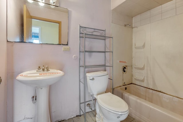 full bathroom featuring tile patterned flooring, sink, toilet, and tiled shower / bath