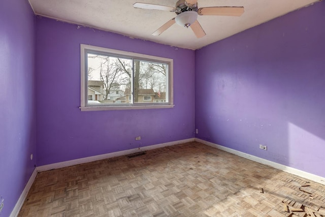 unfurnished room featuring ceiling fan and light parquet flooring