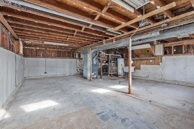 basement with gas water heater, heating unit, and sink