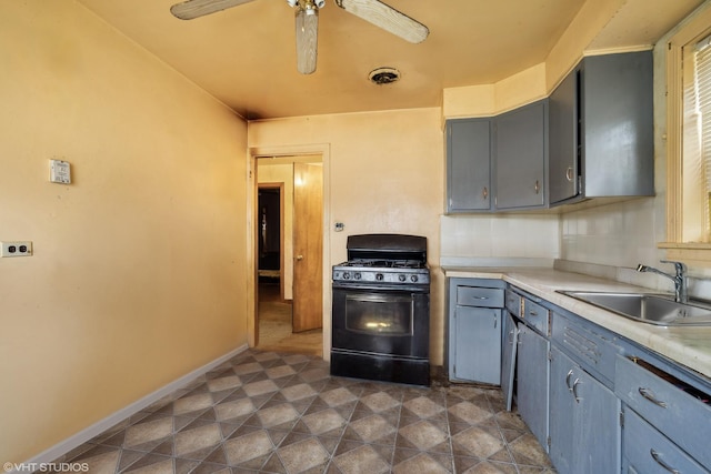 kitchen with black range with gas stovetop, ceiling fan, sink, and gray cabinetry