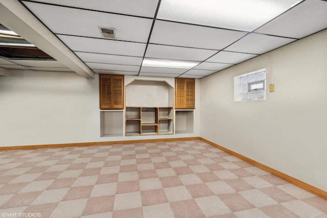 basement featuring a paneled ceiling