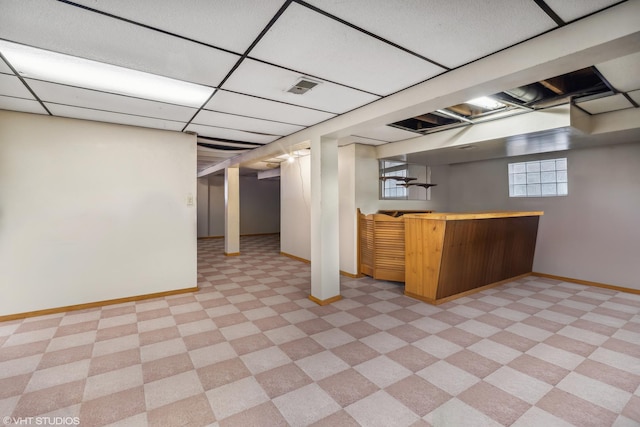 basement featuring a drop ceiling