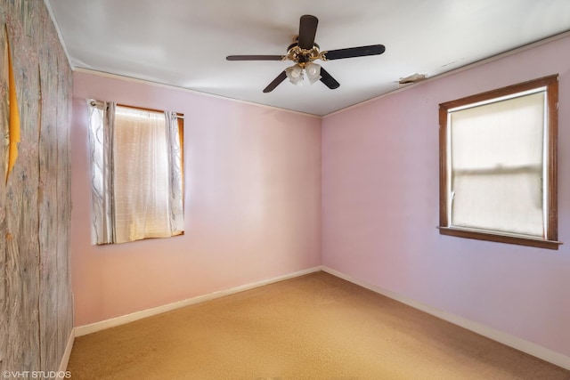 spare room with carpet, plenty of natural light, and ceiling fan