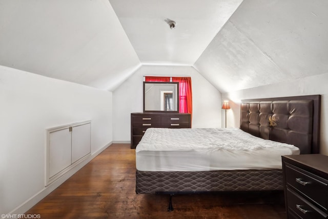 bedroom featuring wood-type flooring and vaulted ceiling