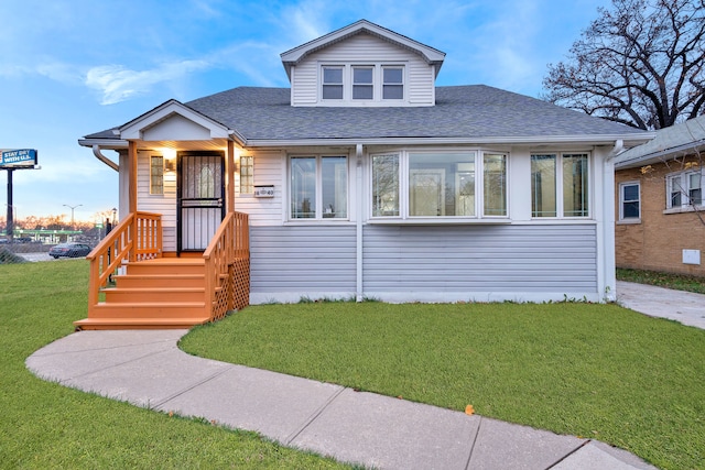 bungalow-style home with a front lawn