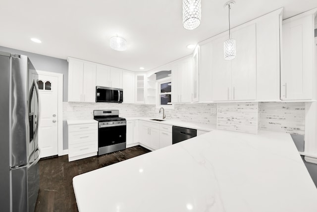 kitchen featuring white cabinets, decorative light fixtures, dark hardwood / wood-style flooring, and stainless steel appliances