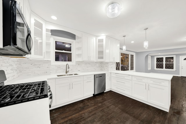 kitchen with pendant lighting, white cabinets, sink, stainless steel dishwasher, and range with gas cooktop