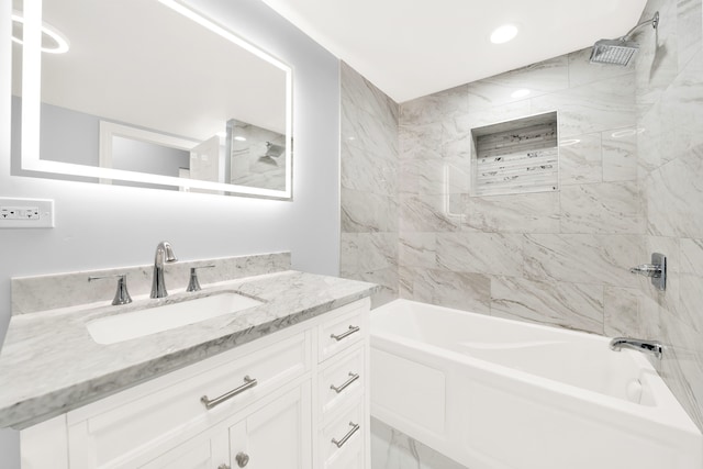 bathroom featuring vanity and tiled shower / bath combo