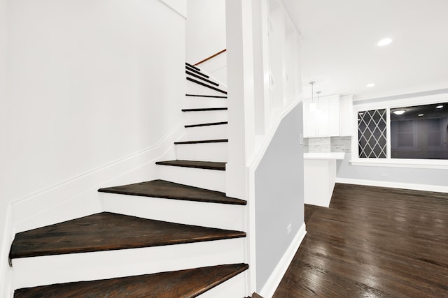 stairs with hardwood / wood-style floors