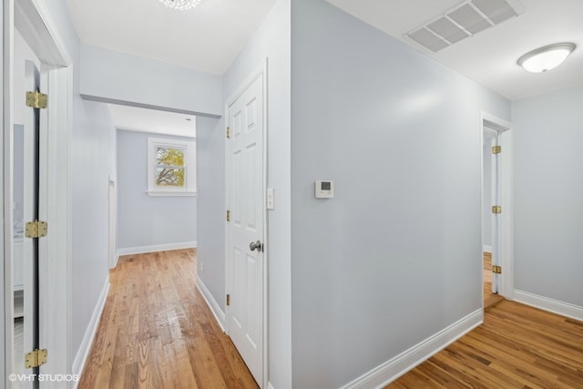 hall with light hardwood / wood-style flooring