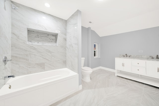 bathroom with vanity, vaulted ceiling, and toilet