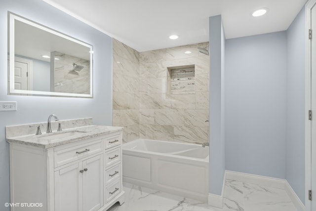 bathroom featuring vanity and tiled shower / bath combo