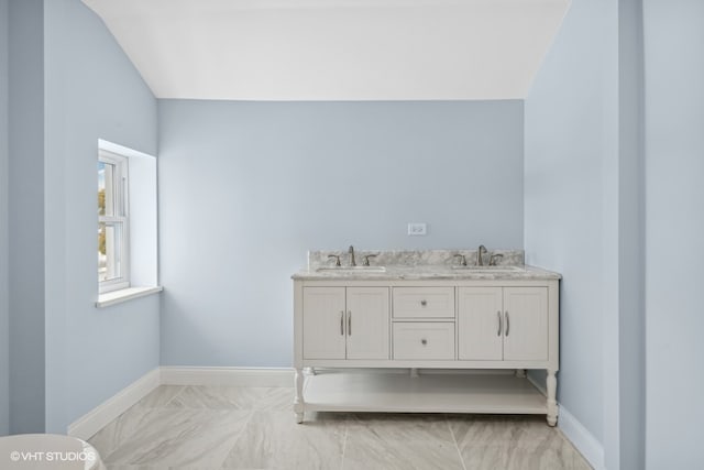 bathroom with vanity and vaulted ceiling