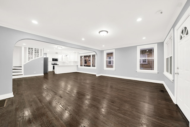 unfurnished living room with crown molding and dark hardwood / wood-style floors