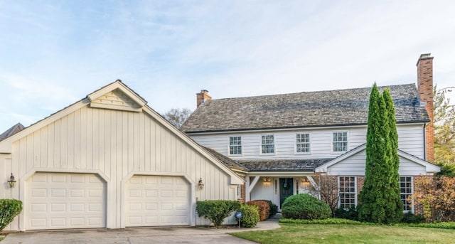 view of front facade with a garage and a front lawn