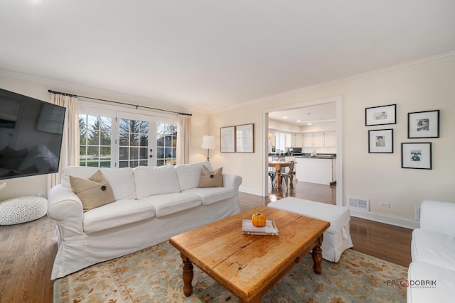 living room with hardwood / wood-style floors and ornamental molding