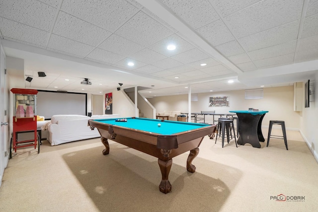 recreation room featuring a drop ceiling, light colored carpet, and billiards