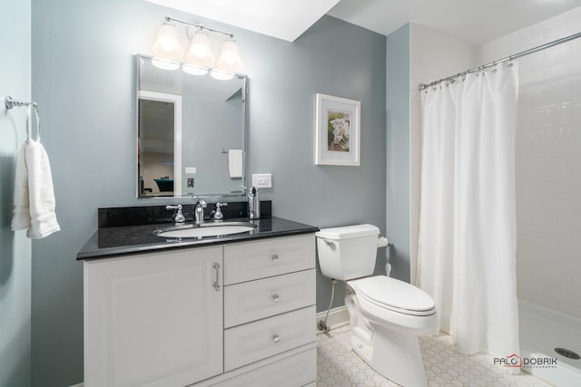 bathroom featuring tile patterned floors, vanity, curtained shower, and toilet