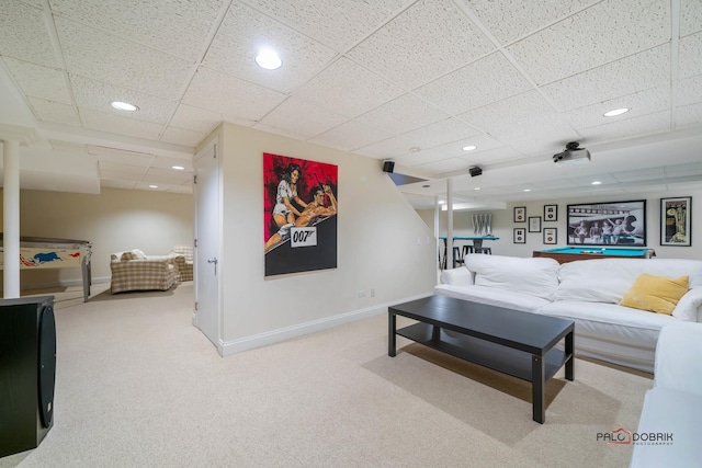 living room with a paneled ceiling and carpet floors