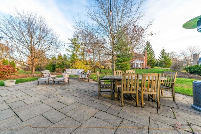 view of patio featuring outdoor lounge area and an outbuilding