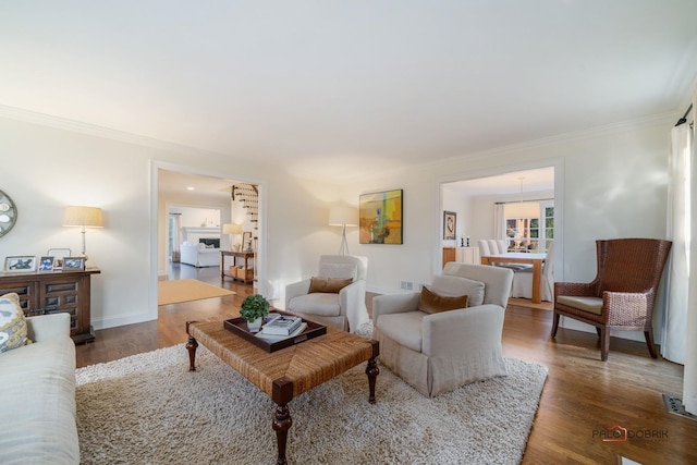 living room with crown molding and dark wood-type flooring