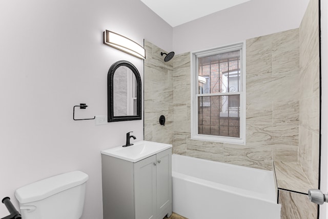 full bathroom with vanity, tiled shower / bath combo, and toilet