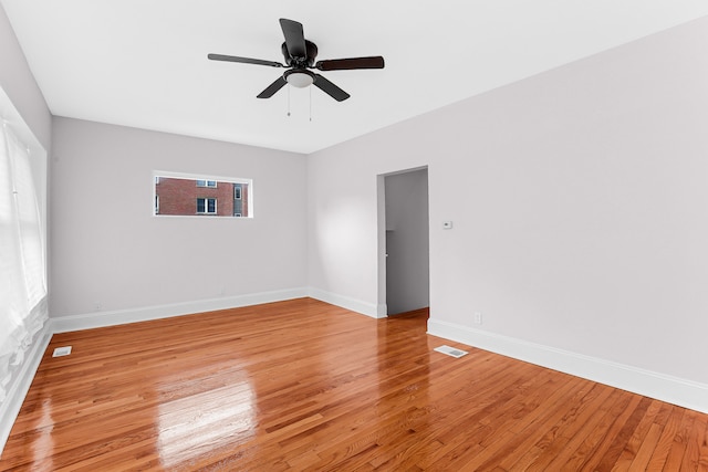 spare room featuring light wood-type flooring and ceiling fan