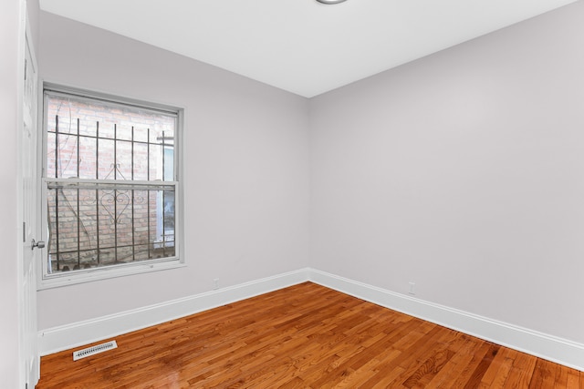 spare room with wood-type flooring