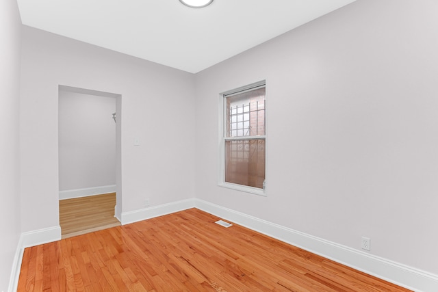 spare room featuring wood-type flooring