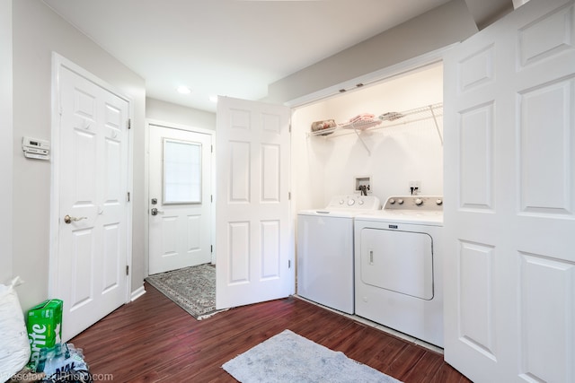 laundry area featuring washing machine and dryer and dark hardwood / wood-style flooring